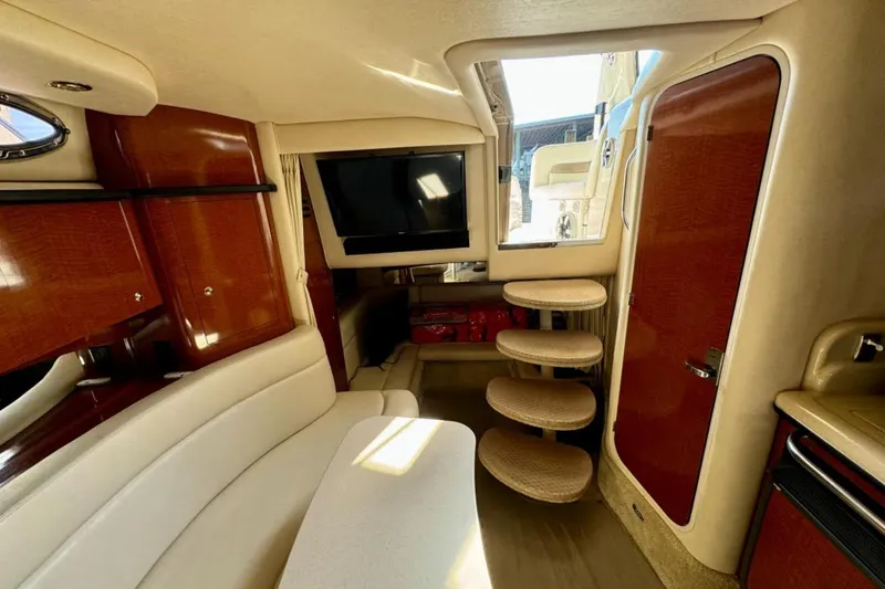 Slide: The Image of 2004 Sea Ray 320 Sundancer boat interior with seating and table at dock. - 7