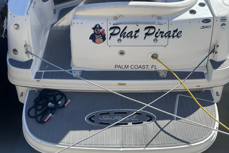 Slide: The Image of 2004 Sea Ray 320 Sundancer interior with seating, table, and kitchenette. - 9