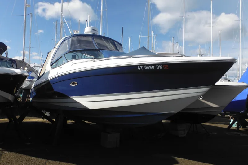 The Image of 2003 Formula 280 Bowrider boat on display, surrounded by other vessels, under a clear sky. - 1