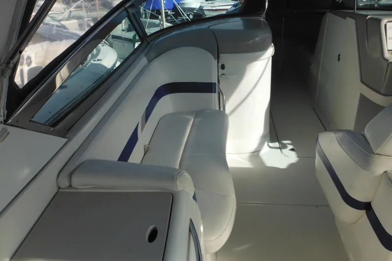 Slide: The Image of Interior of a 2003 Formula 280 Bowrider boat with white seating and blue accents. - 11