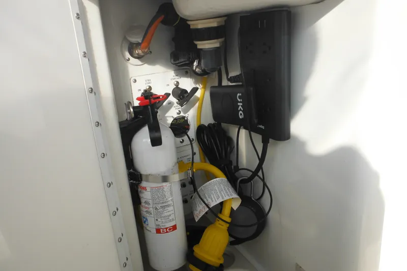 Slide: The Image of Storage compartment of a 2003 Formula 280 Bowrider with fire extinguisher and electrical equipment. - 16