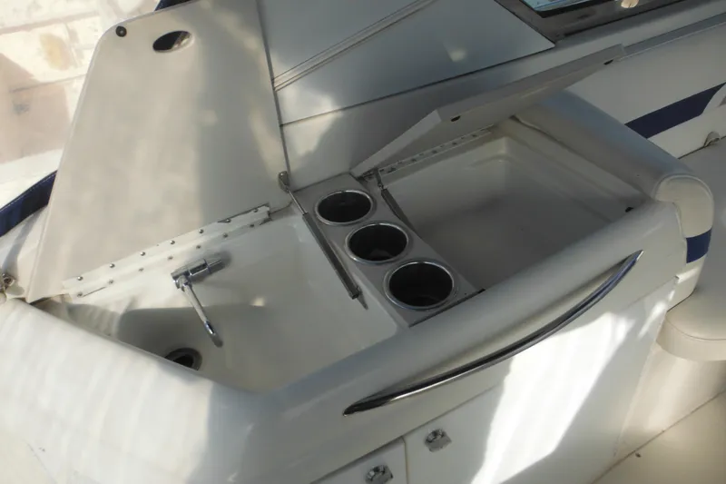 Slide: The Image of 2003 Formula 280 Bowrider boat interior with open storage compartment and cup holders. - 18