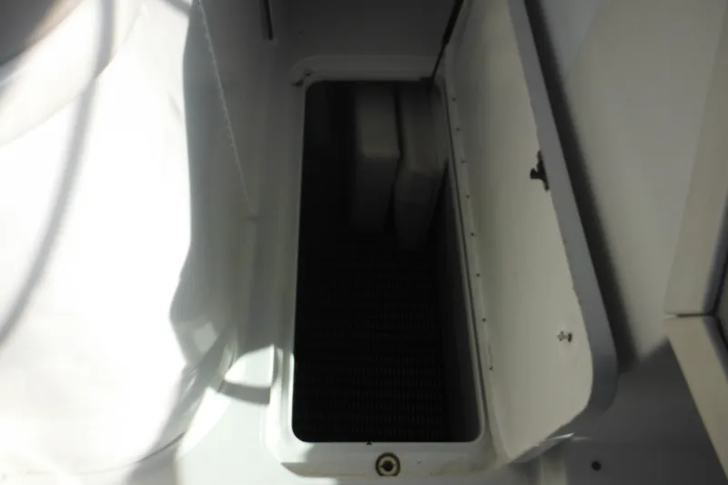 Slide: The Image of Open storage compartment in 2003 Formula 280 Bowrider boat. - 21