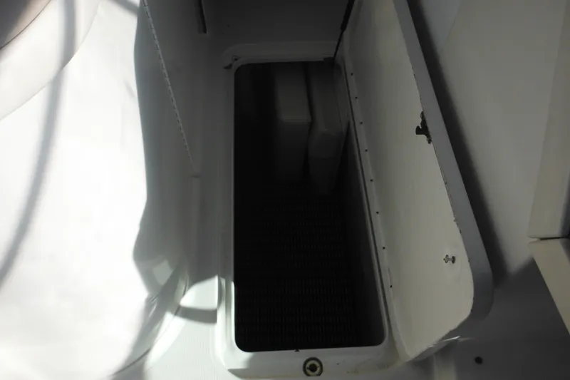 Slide: The Image of Storage compartment in a 2003 Formula 280 Bowrider boat, open with visible interior. - 22