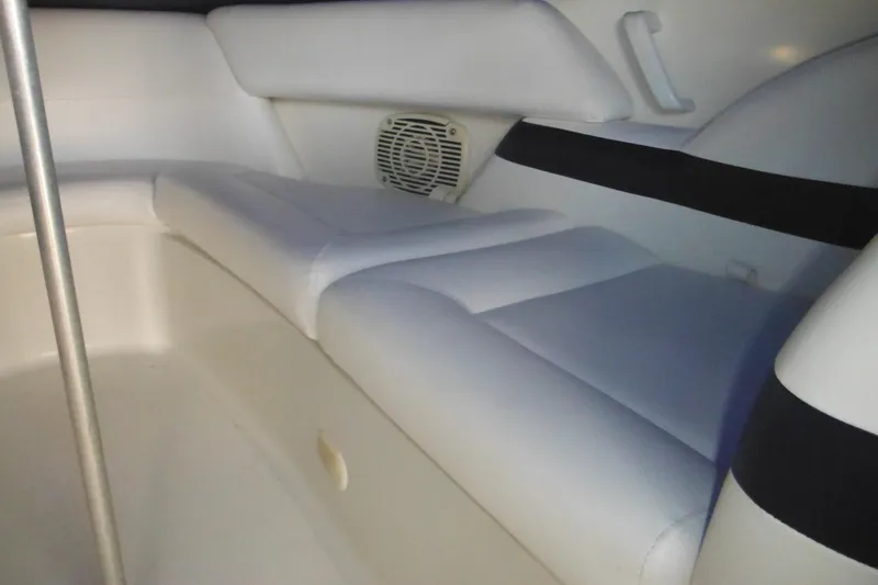 Slide: The Image of Interior seating of a 2003 Formula 280 Bowrider boat, featuring white upholstery. - 29