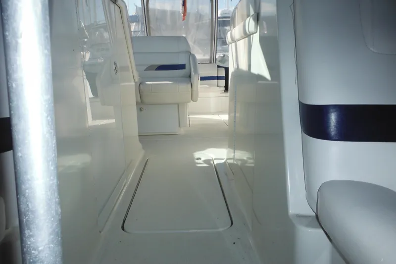 Slide: The Image of Interior view of 2003 Formula 280 Bowrider boat, featuring white seating and sleek design. - 33
