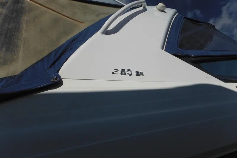 Slide: The Image of 2003 Formula 280 Bowrider boat with blue cover and clear sky background. - 48