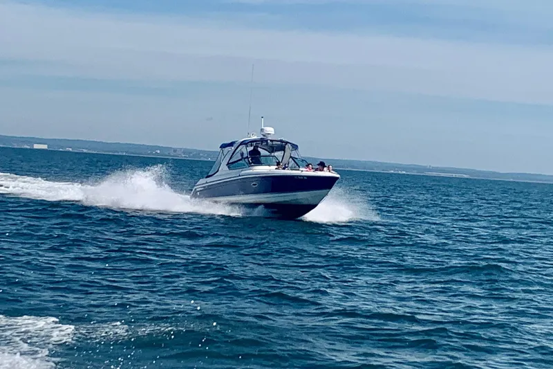 Slide: The Image of 2003 Formula 280 Bowrider cruising on open water under clear skies. - 49