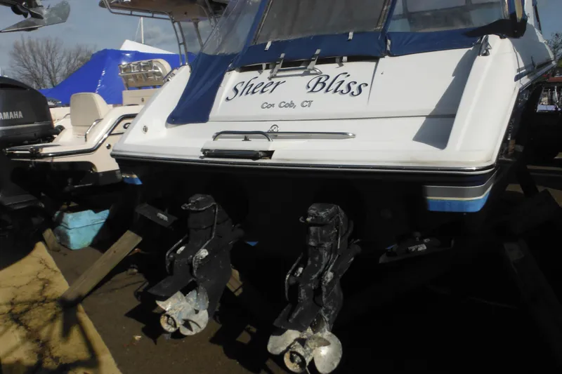 Slide: The Image of 2003 Formula 280 Bowrider boat with dual propellers, named "Sheer Bliss," docked in Cos Cob, CT. - 5