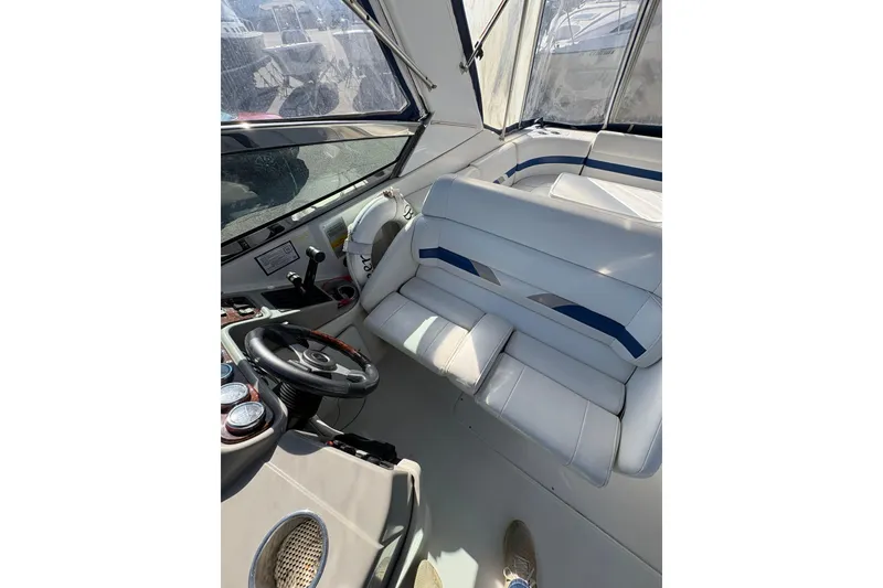 Slide: The Image of Interior of 2003 Formula 280 Bowrider boat with white seating and steering wheel. - 54