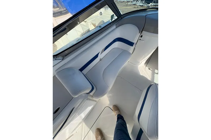 Slide: The Image of Interior of a 2003 Formula 280 Bowrider boat with white and blue seating. - 55