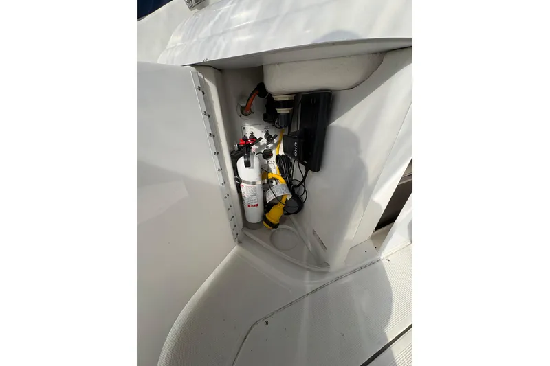 Slide: The Image of Storage compartment in a 2003 Formula 280 Bowrider boat, featuring safety equipment. - 57