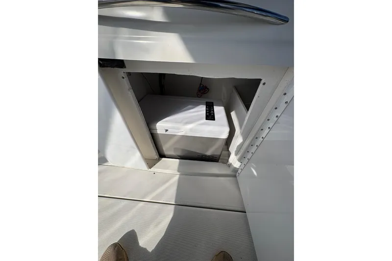 Slide: The Image of Storage compartment on a 2003 Formula 280 Bowrider boat, featuring a built-in cooler. - 58