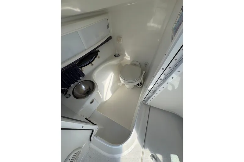 Slide: The Image of 2003 Formula 280 Bowrider boat bathroom with toilet and sink. - 60