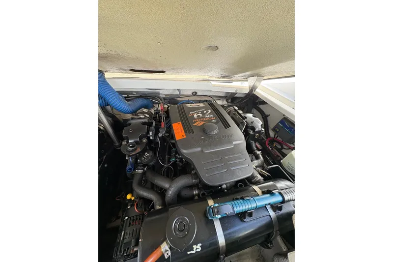 Slide: The Image of Engine compartment of a 2003 Formula 280 Bowrider boat, featuring a Mercury engine. - 65