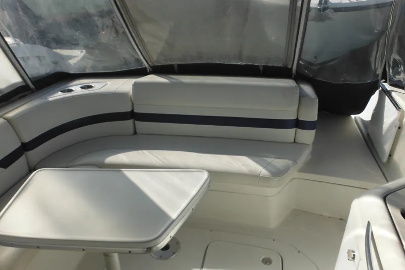 Slide: The Image of 2003 Formula 280 Bowrider interior with seating and table, featuring cup holders. - 7