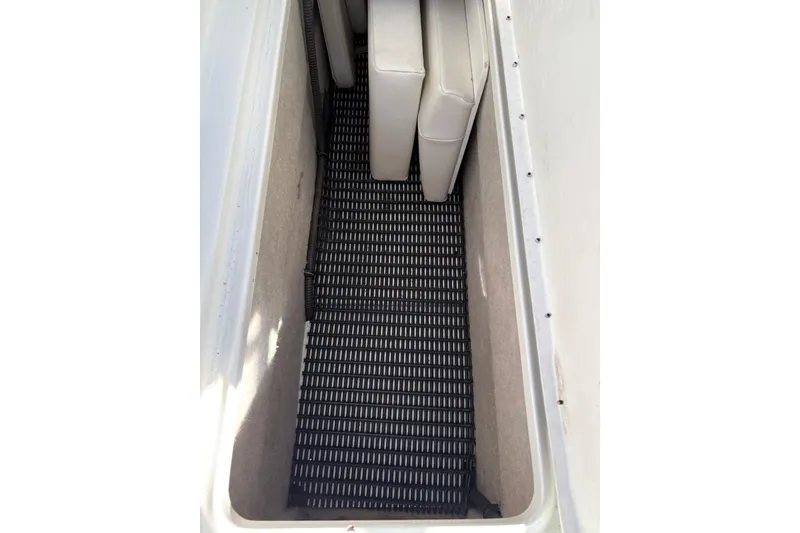 Slide: The Image of Storage compartment in a 2003 Formula 280 Bowrider boat with cushioned seating. - 70