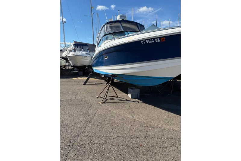 Slide: The Image of 2003 Formula 280 Bowrider boat on stands in a marina, clear sky background. - 73