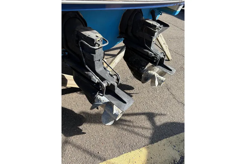 Slide: The Image of 2003 Formula 280 Bowrider boat propellers on pavement, showing dual outdrives. - 74