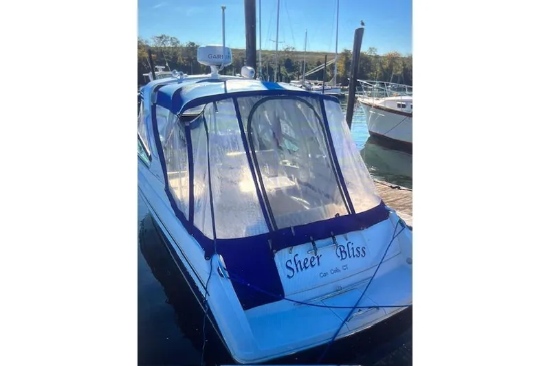 Slide: The Image of 2003 Formula 280 Bowrider boat named "Sheer Bliss" docked at a marina. - 76