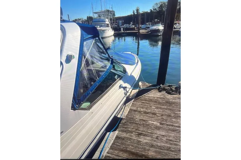Slide: The Image of 2003 Formula 280 Bowrider docked at a marina with blue canopy. - 77
