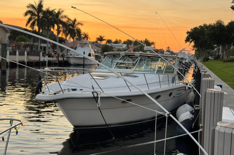 Slide: The Image of Interior view of a 2000 Tiara 37 Open yacht with white seating and helm. - 13