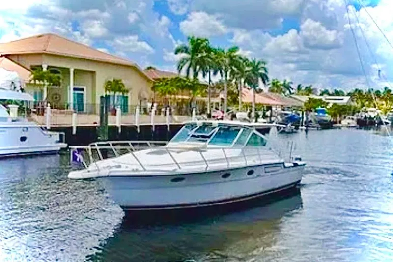 Slide: The Image of 2000 Tiara 37 Open yacht cruising on a sunny day in a scenic waterway. - 2