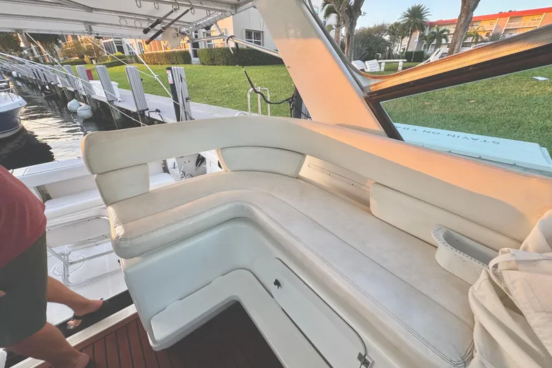 Slide: The Image of Cozy interior of 2000 Tiara 37 Open yacht with wooden table and white seating. - 22