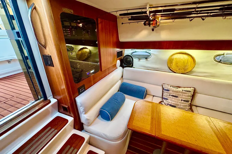 Slide: The Image of Interior of 2000 Tiara 37 Open yacht with fishing rods and cozy seating area. - 35