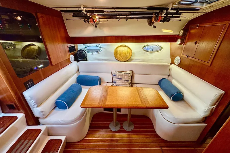 Slide: The Image of Interior of 2000 Tiara 37 Open yacht with white seating and wooden accents. - 36