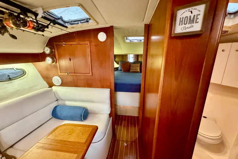 Slide: The Image of Interior of 2000 Tiara 37 Open boat with fishing rods and wooden cabinetry. - 38