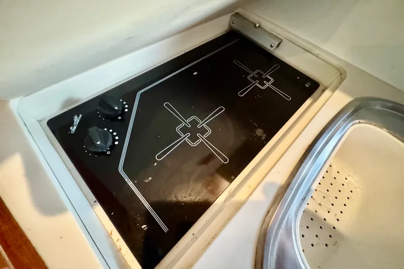 Slide: The Image of Bathroom interior of 2000 Tiara 37 Open yacht, featuring sink, mirror, and skylight. - 50