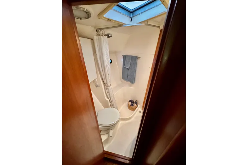 Slide: The Image of Interior of 2000 Tiara 37 Open yacht with wooden cabinetry and porthole. - 54