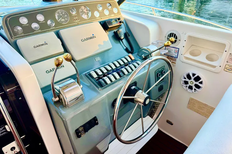 Slide: The Image of 2000 Tiara 37 Open boat with open storage compartment and fishing gear. - 79