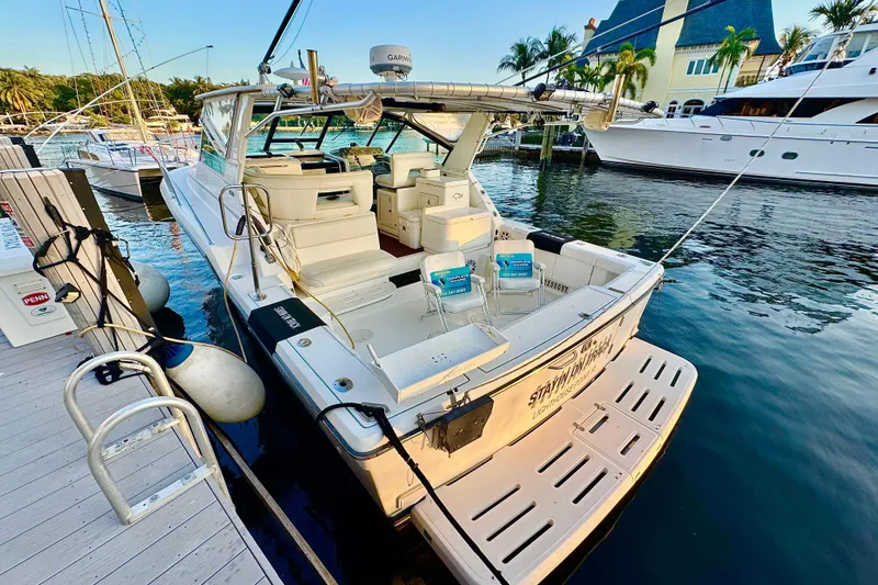 Slide: The Image of Control panel of a 2000 Tiara 37 Open yacht with various switches and gauges. - 92