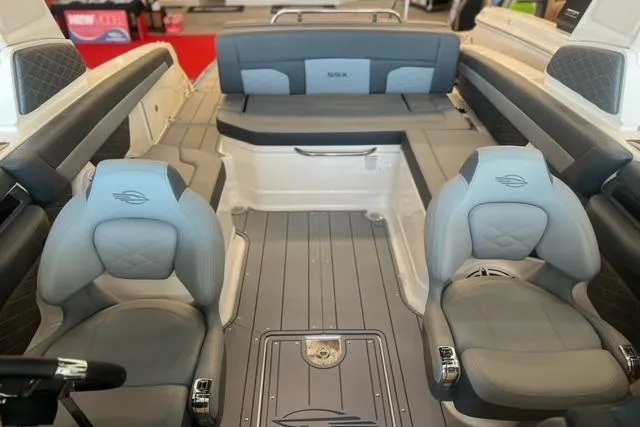 Slide: The Image of 2025 Chaparral 267 SSX boat interior with gray seating and modern design. - 10