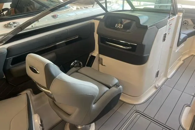 Slide: The Image of 2025 Chaparral 267 SSX boat interior with modern helm and seating. - 15