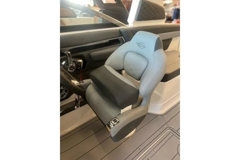Slide: The Image of 2025 Chaparral 267 SSX boat interior with luxurious captain's seat and modern dashboard. - 18