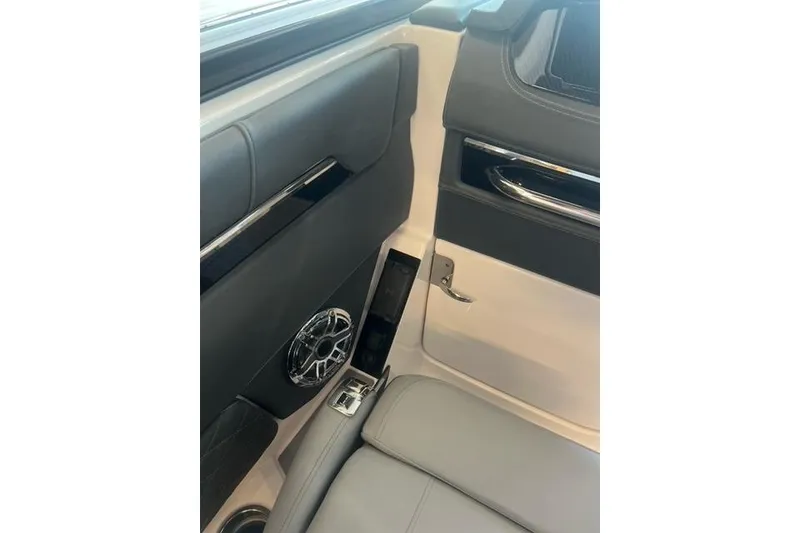 Slide: The Image of Interior of 2025 Chaparral 267 SSX boat, featuring sleek seating and modern speaker design. - 19