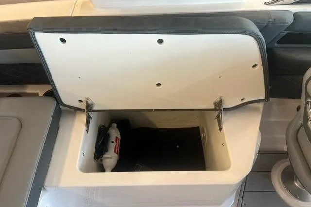 Slide: The Image of Open storage compartment in 2025 Chaparral 267 SSX boat interior. - 21