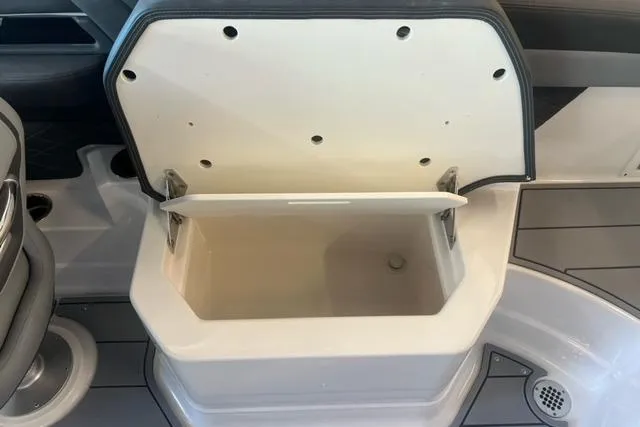 Slide: The Image of Open storage compartment on 2025 Chaparral 267 SSX boat interior. - 23