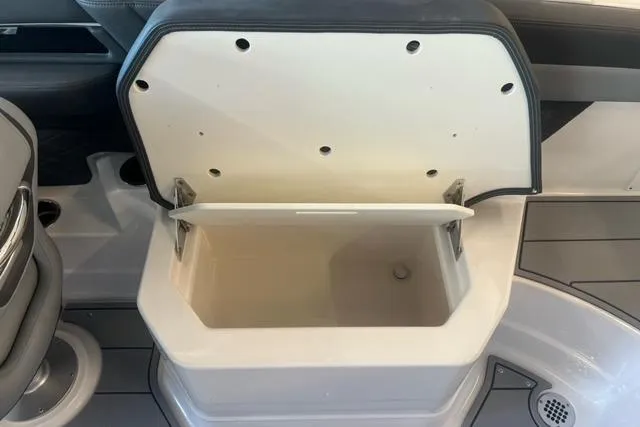 Slide: The Image of Open storage compartment on 2025 Chaparral 267 SSX boat interior. - 24