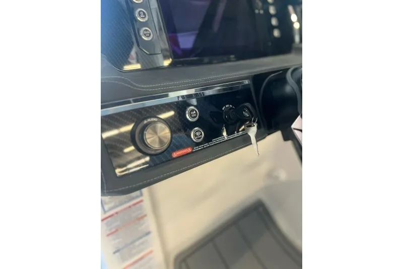 Slide: The Image of Dashboard of 2025 Chaparral 267 SSX boat with control panel and ignition key. - 28