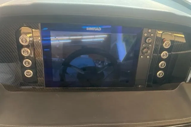 Slide: The Image of Dashboard of 2025 Chaparral 267 SSX with Simrad display and control buttons. - 30