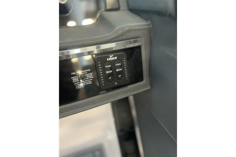 Slide: The Image of Control panel of 2025 Chaparral 267 SSX boat with Lenco trim tab switches. - 31