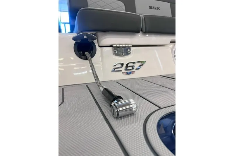 Slide: The Image of 2025 Chaparral 267 SSX boat interior detail with logo and plug. - 43