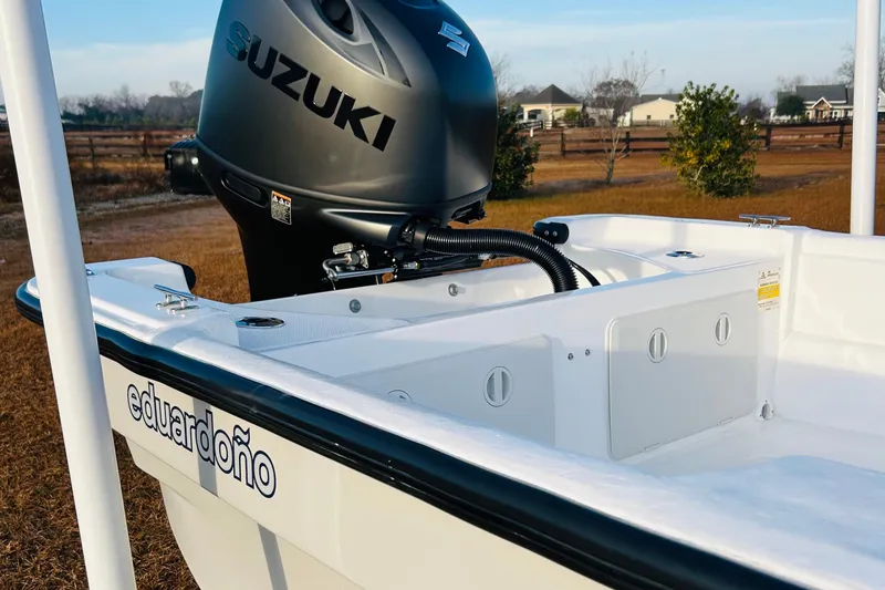 Slide: The Image of 2025 Eduardono Panga 22 boat with Suzuki outboard motor, parked outdoors. - 5