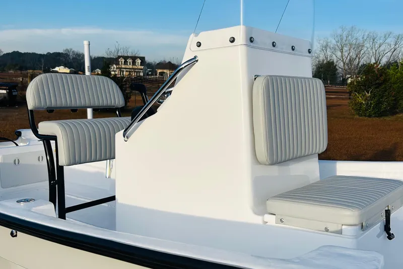 Slide: The Image of 2025 Panga Eduardono Panga 22 boat interior with striped seating and steering console. - 6