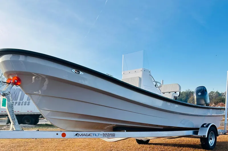 Slide: The Image of 2025 Panga Eduardono Panga 22 boat on trailer, clear sky background. - 7