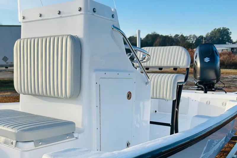 Slide: The Image of 2025 Panga Eduardono Panga 22 boat interior with cushioned seating and Suzuki outboard motor. - 8